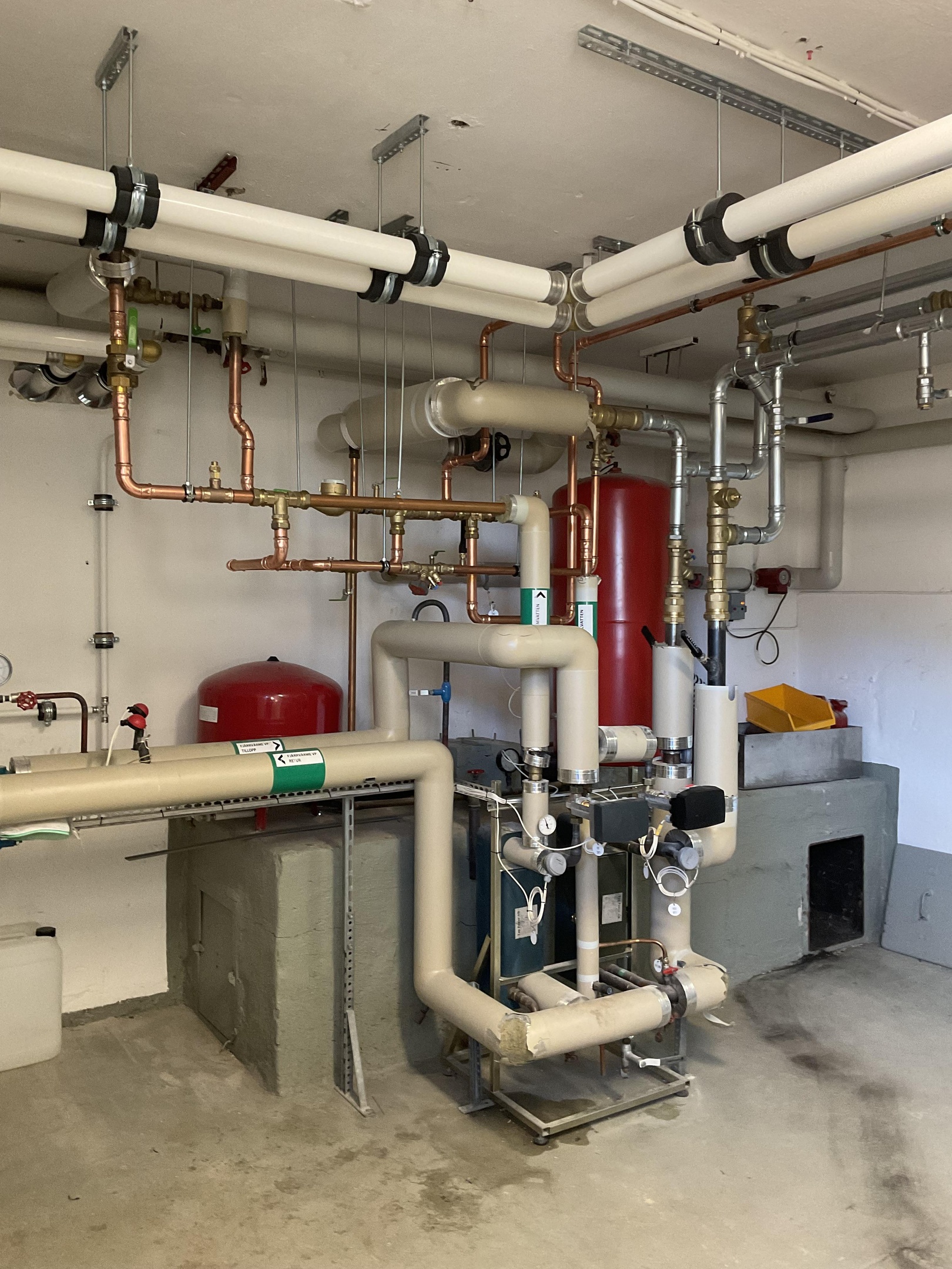 pipes and valves in a room with orange table
